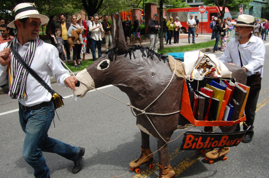 BiblioBurro’s chances of winning? “Edison [Alvarez-Morales, at left] is an excellent folkloric dancer, so he’s quick on his feet. I’m a jogger,” Scott Ruescher (right) said. “But the burro is very stubborn.” (Greg Cook)