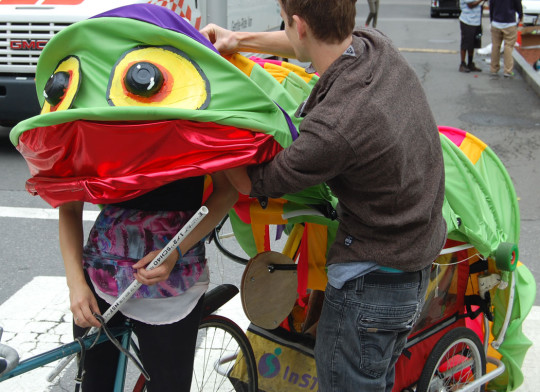 The Somerville-based “Everything Muffin Collective" preps their caterpillar-bike before the race. (Greg Cook)